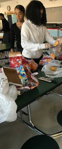 JV Girls Basketball team preparing post-game snacks for the Middle School Flag football team on 10/1/19.
